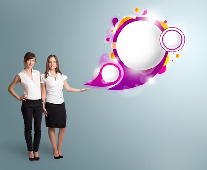 Attractive young women presenting abstract speech bubble copy space