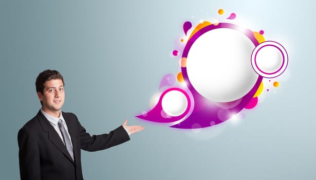 Handsome young man presenting abstract speech bubble copy space