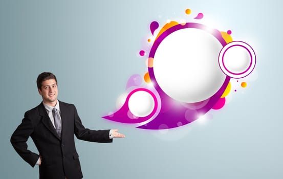 Handsome young man presenting abstract speech bubble copy space