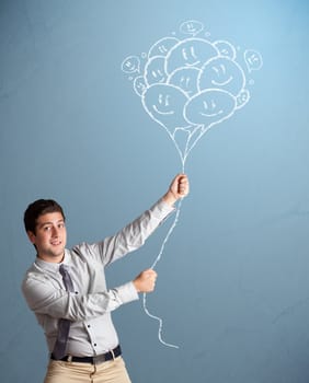 Happy young man holding smiling balloons drawing