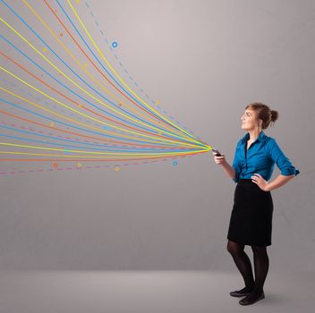 Happy young girl holding a phone with colorful abstract lines