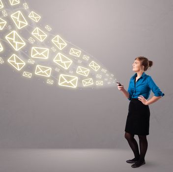 attractive young lady standing and holding a phone with message icons