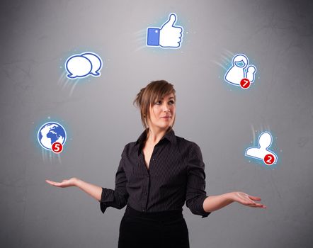 attractive young woman standing and juggling with social network icons