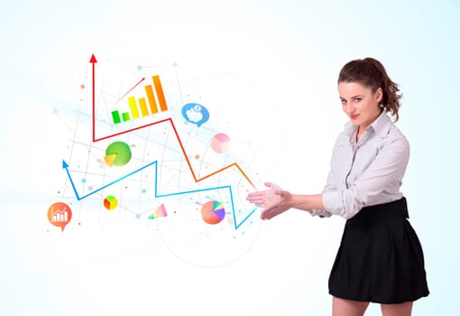 Young business woman presenting colorful charts and diagrams on bright background
 