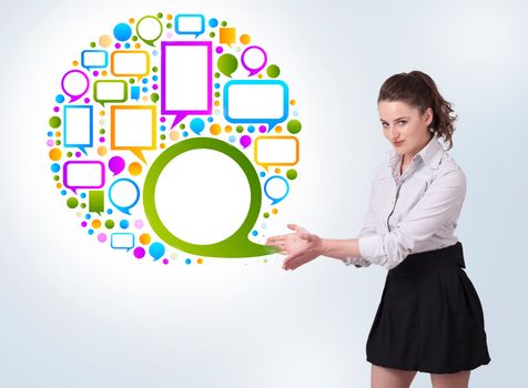 Young business woman presenting colourful speach bubble on bright background