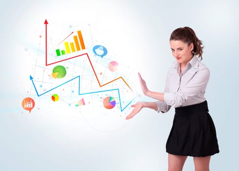Young business woman presenting colorful charts and diagrams on bright background
 