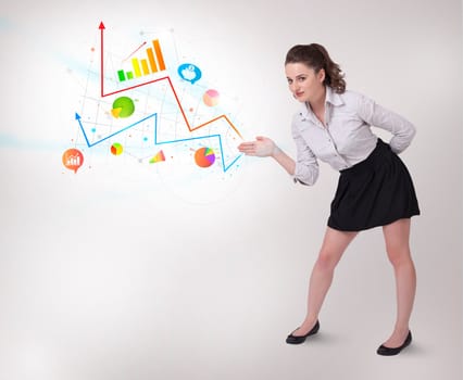 Young business woman presenting colorful charts and diagrams on bright background
 