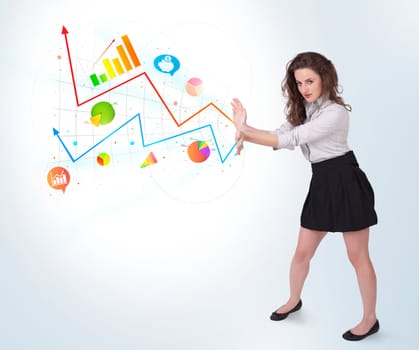 Young business woman presenting colorful charts and diagrams on bright background
 