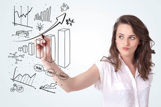 Young business woman drawing various diagrams on whiteboard