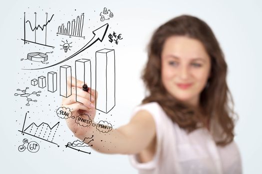 Young business woman drawing various diagrams on whiteboard