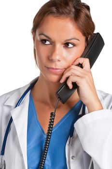 Young female doctor with scrubs and a stethoscope talking on the phone