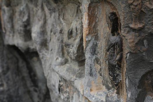 Carved stone Buddha at Longmen Grottoes, a UNESCO World Heritage Site in Luoyang, China
