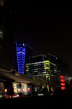 Colorful illuminated skyscrapers in Beijing and traditional Chinese lanterns

