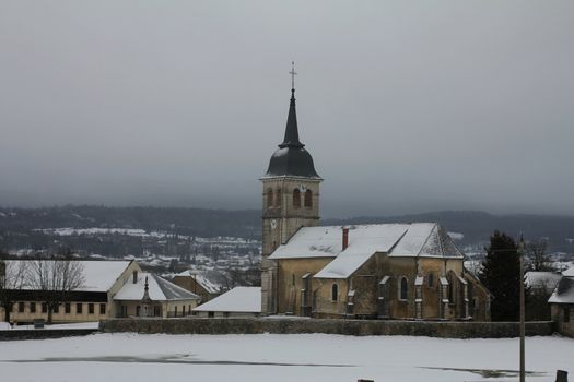 Snow covered church of a little village in the French countryside
