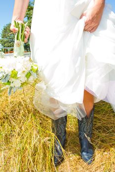 A bride wearing her black and blue cowboy (or cowgirl) boots on her wedding day.