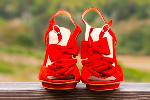 Red wedding shoe stilettos on a bride's wedding day before she puts them on.
