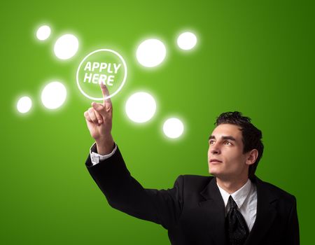 Business man pressing a "Apply HERE" button. 