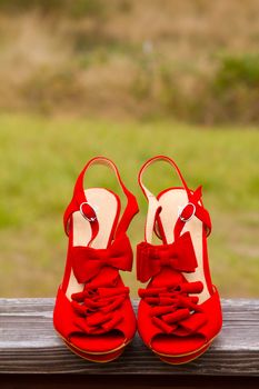 Red wedding shoe stilettos on a bride's wedding day before she puts them on.