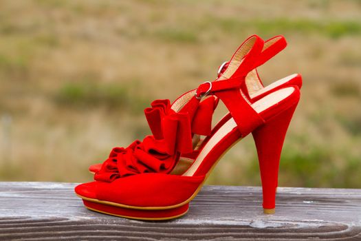 Red wedding shoe stilettos on a bride's wedding day before she puts them on.