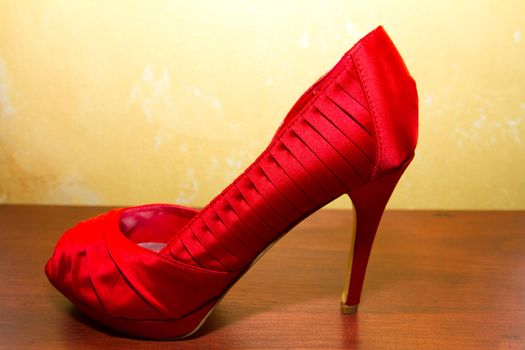 Red wedding shoe stilettos on a bride's wedding day before she puts them on.