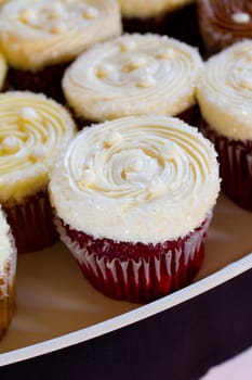 A variety of cupcakes from a dessert buffet at a wedding reception.