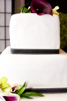 A very traditional white wedding cake at the reception for a bride and groom on their wedding day.