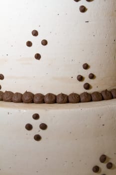 A very traditional white wedding cake at the reception for a bride and groom on their wedding day.