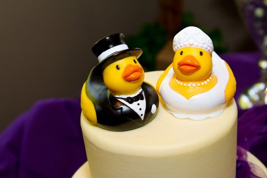 Rubber ducks are the cake toppers for this wedding cake at a very non-traditional reception for the bride and groom.