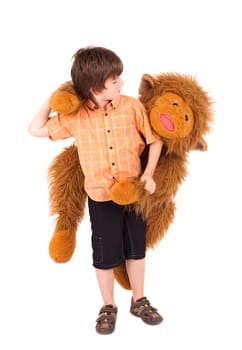 Little boy embraces a teddy bear, isolated on white
