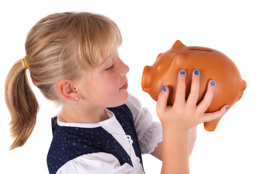 Little girl kissing piggy bank, isolated on white