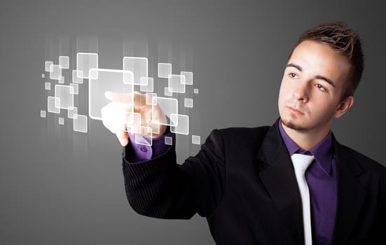 Businessman pressing high tech type of modern buttons on a virtual background