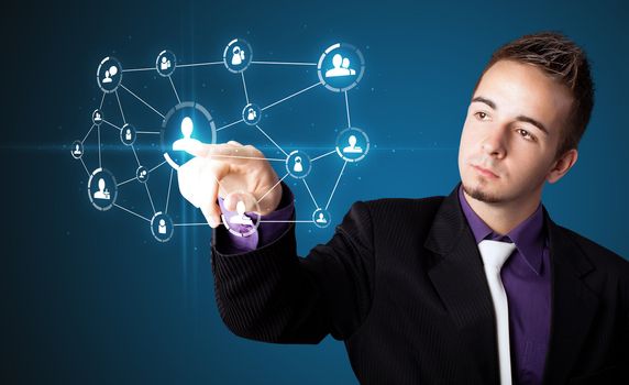 Businessman pressing modern social buttons on a virtual background