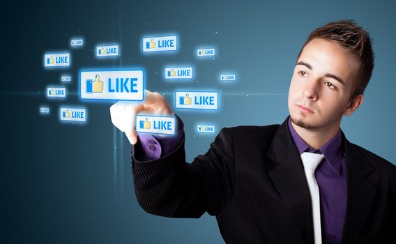 Businessman pressing modern social buttons on a virtual background