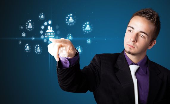 Businessman pressing modern social buttons on a virtual background