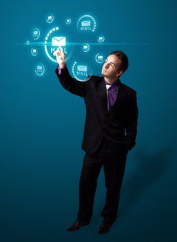Businessman pressing messaging type of modern icons with virtual background