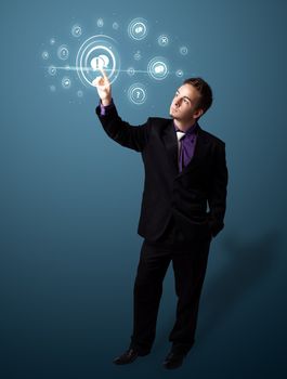 Businessman pressing modern social buttons on a virtual background