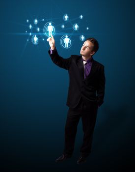 Businessman pressing modern social buttons on a virtual background