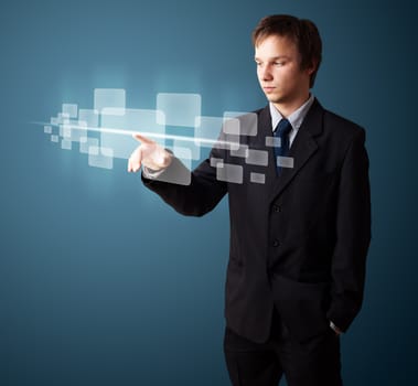 Businessman pressing high tech type of modern buttons on a virtual background