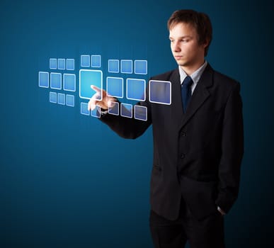 Businessman pressing high tech type of modern buttons on a virtual background