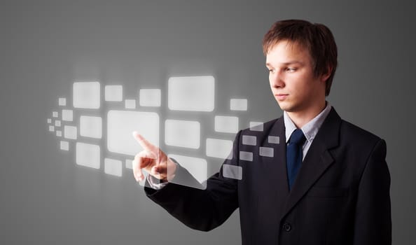 Businessman pressing high tech type of modern buttons on a virtual background