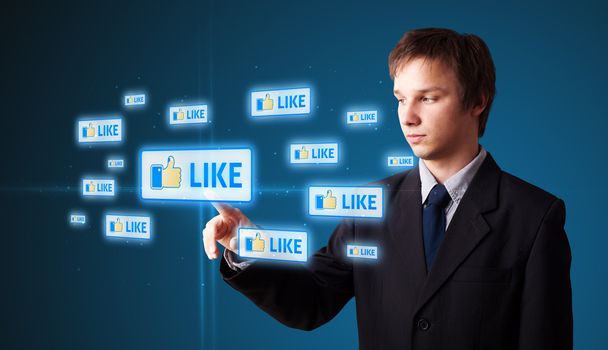 Businessman pressing modern social buttons on a virtual background