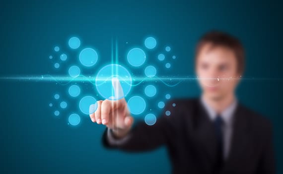 Businessman pressing high tech type of modern buttons on a virtual background