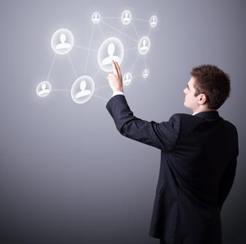 Young business man pressing a digital social network icon.