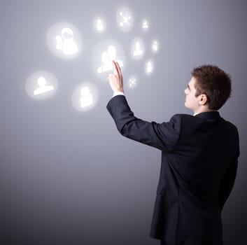 Young business man pressing a digital social network icon.