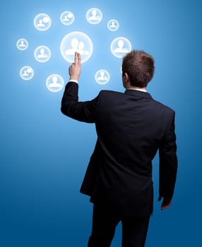 Businessman hand pressing Social network icon