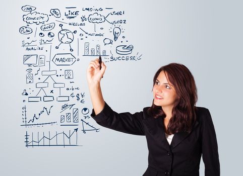 Young woman drawing business scheme and icons on whiteboard
