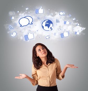 pretty young woman looking social network icons in abstract cloud