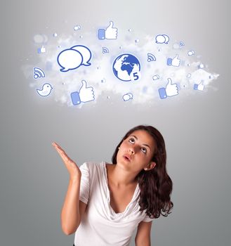 pretty young woman looking social network icons in abstract cloud