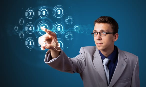 Businessman pressing high tech type of modern buttons on a virtual background