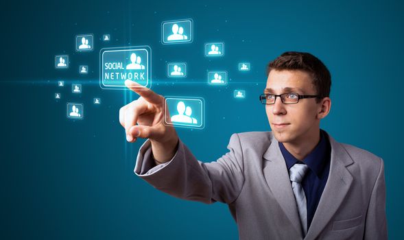 Businessman pressing modern social buttons on a virtual background